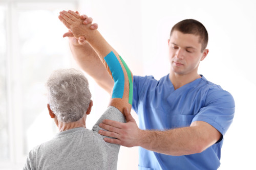 senior with a physical therapist