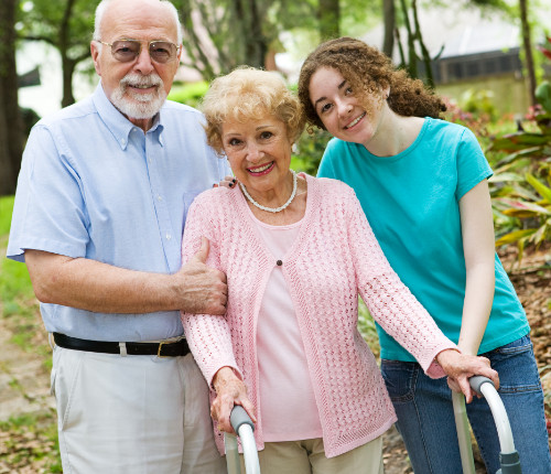 Two seniors with caregiver